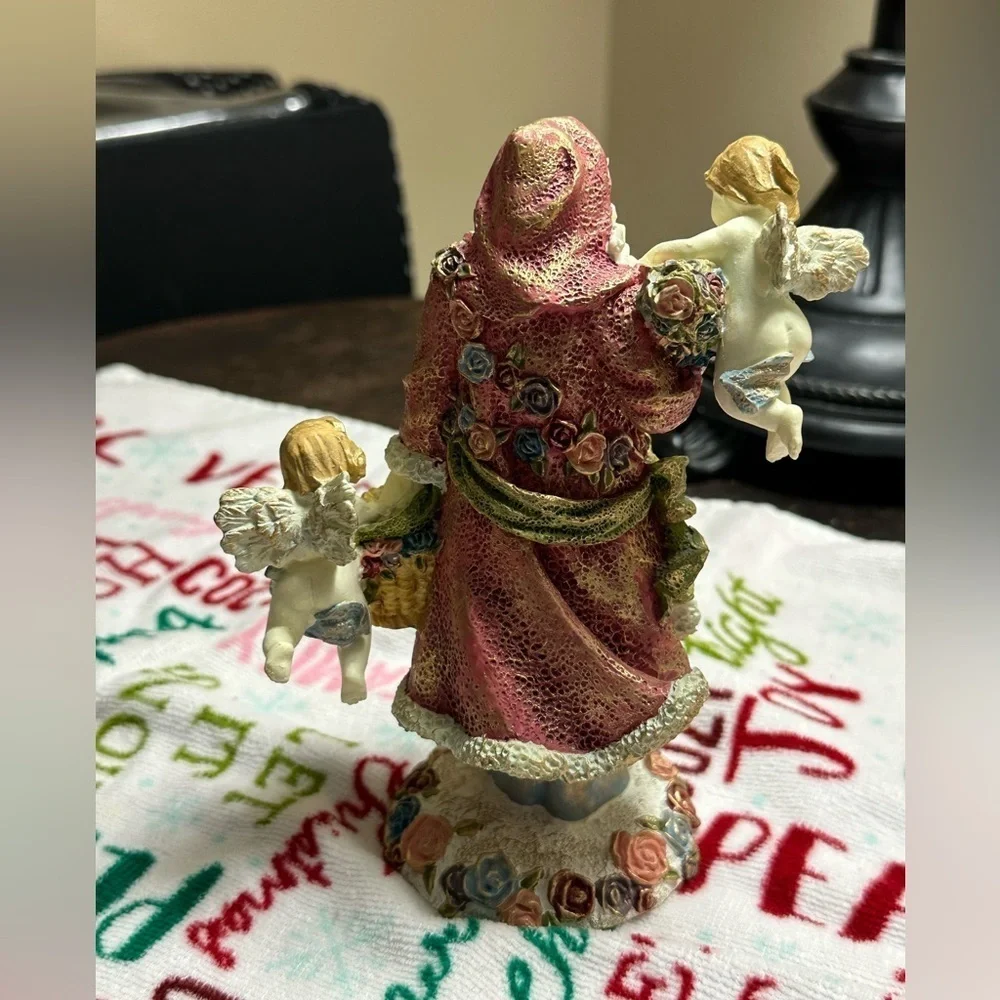 Festive Santa Figurine with Cherubs
